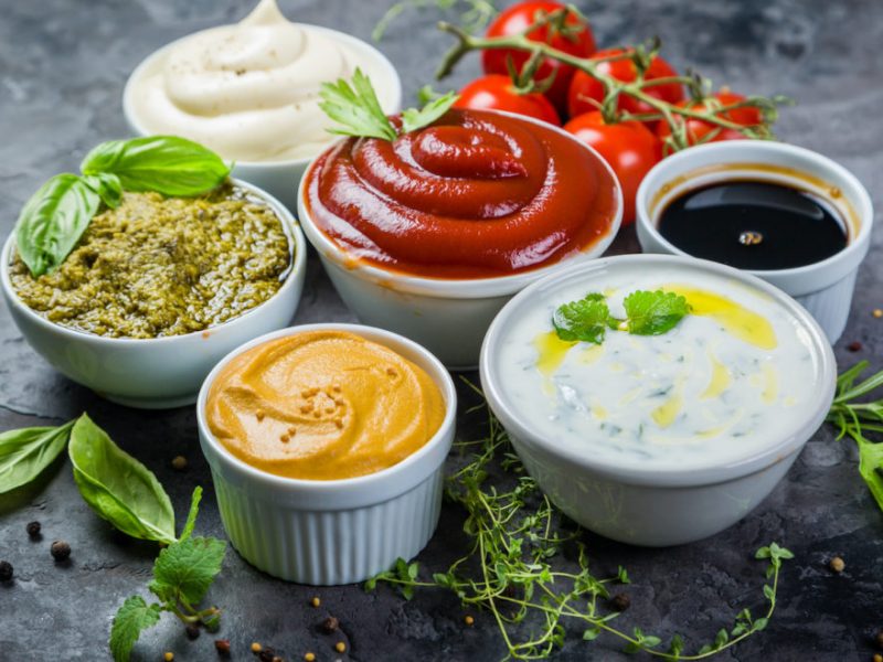 Selection of different sauces in bowls, copy space
